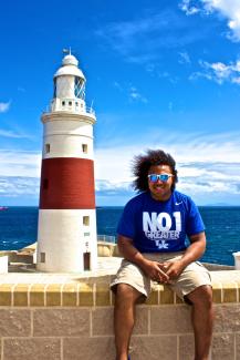 Student in front of light house